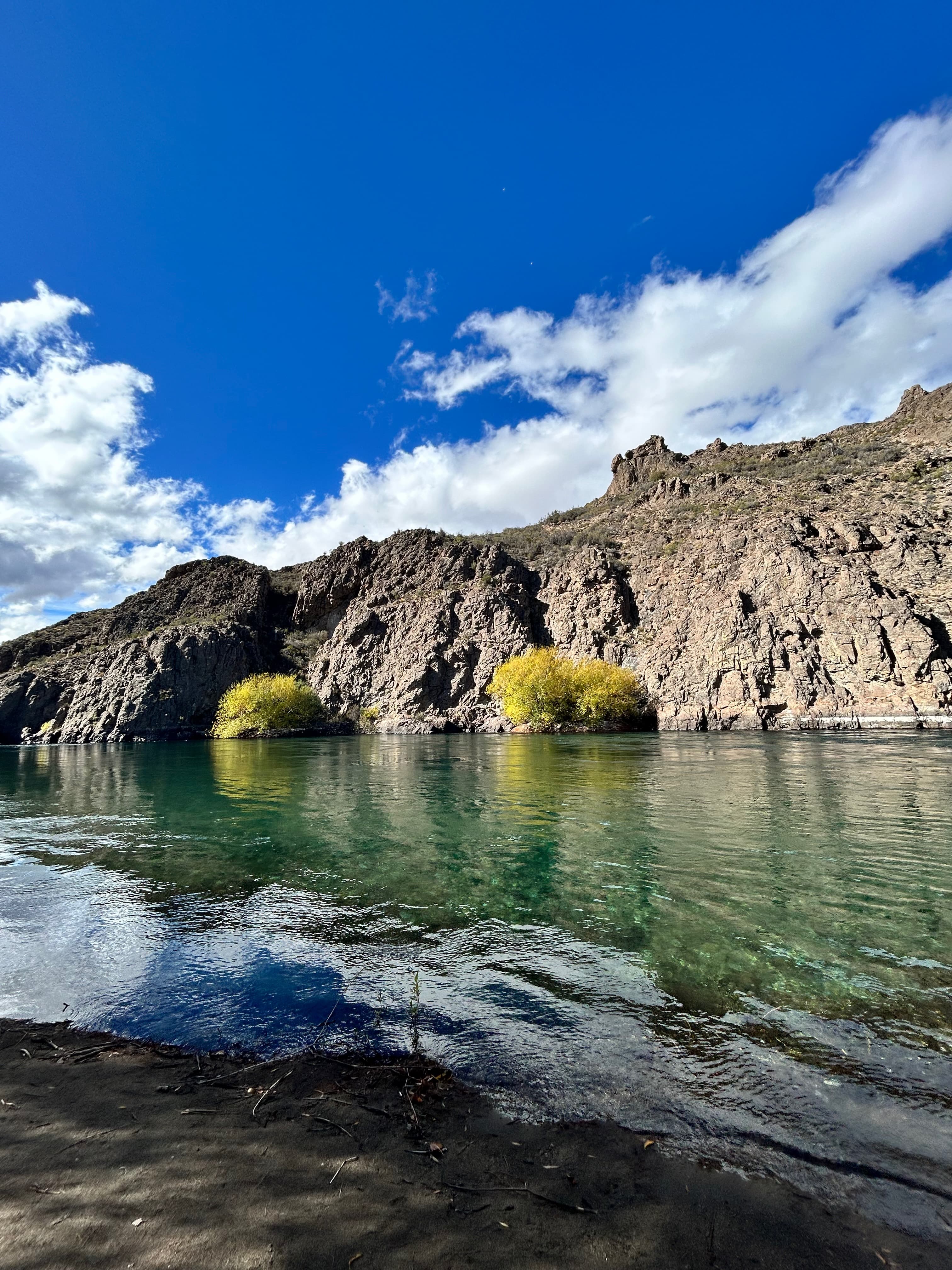 Turquoise Patagonian river between rocky cliffs under a blue sky